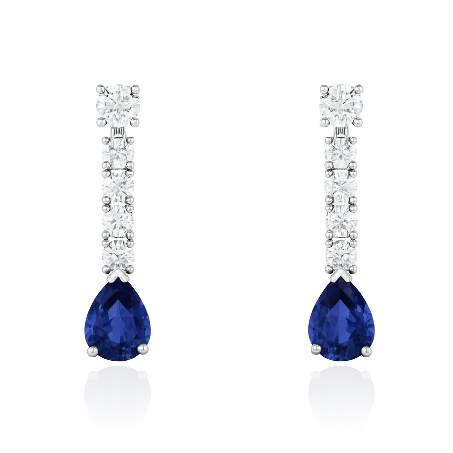 Pair of earrings with blue teardrop gemstones and diamond-studded halo on a white background