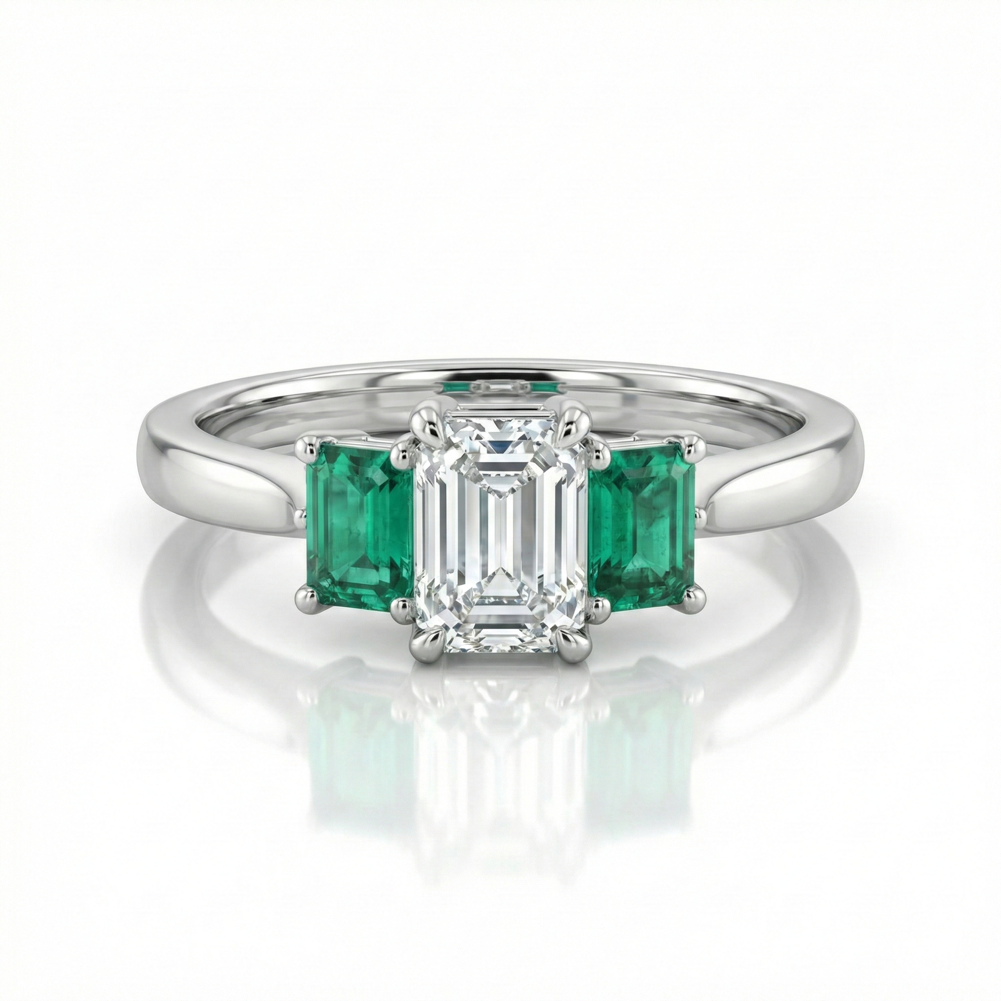 0.38ct Trilogy Setting Emerald Cut Engagement Ring with Green emerald side stones Chloe's Jewellers