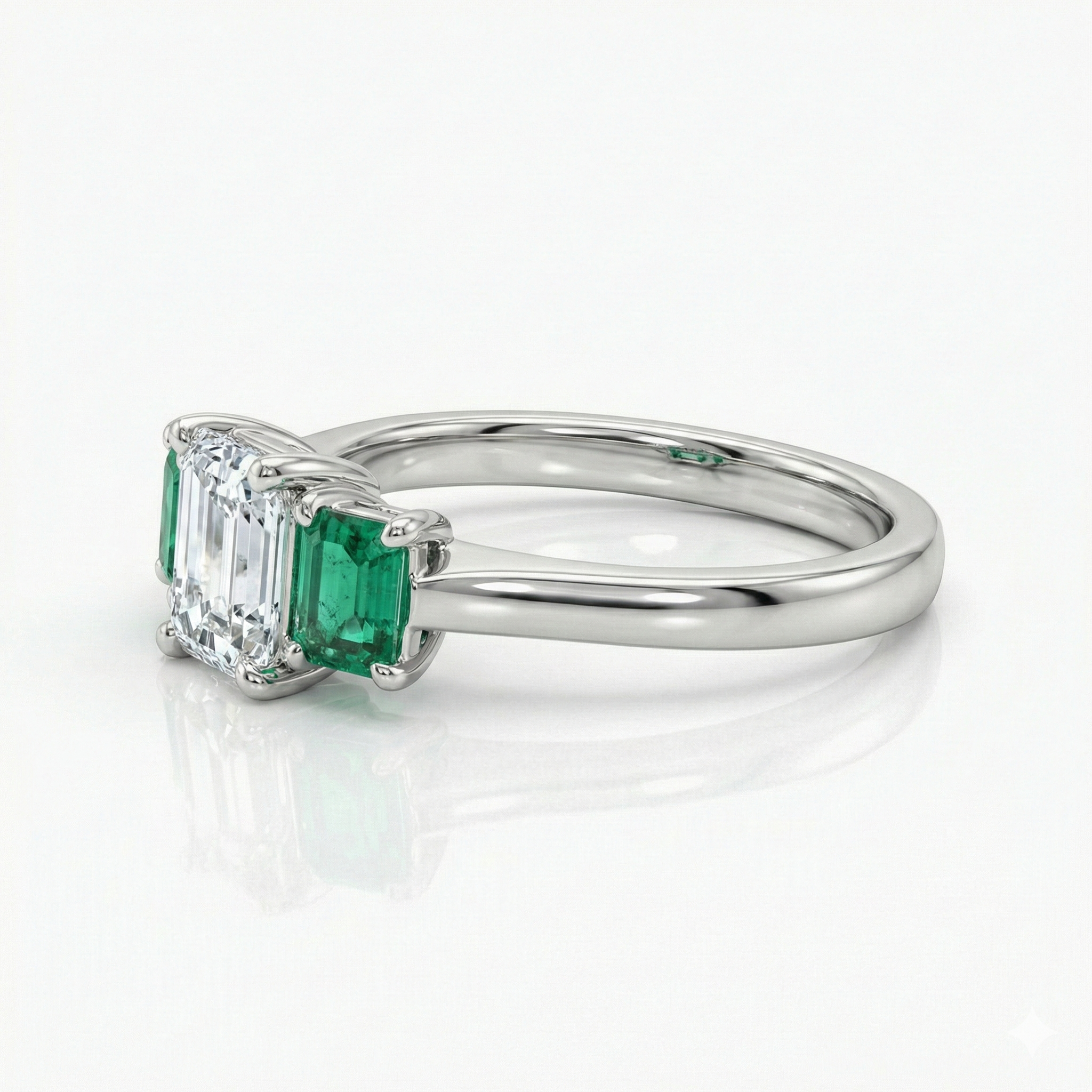 0.38ct Trilogy Setting Emerald Cut Engagement Ring with Green emerald side stones Chloe's Jewellers
